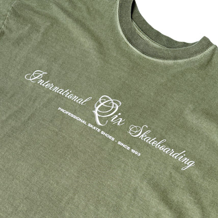 CAMISETA QIX BOX INTERNACIONAL SKATEBOARDS OLIVA ESTONADO